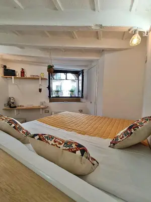 a bedroom with two beds and a window at Il Pirtuso in Palermo