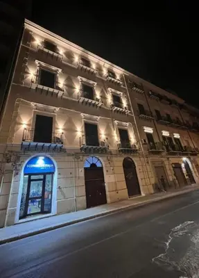 a building with a blue sign on the side of it at Borbon Home luxury rooms & SPA in Palermo