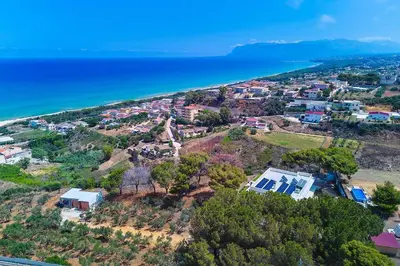 an aerial view of a house on a hill next to the ocean at Villa Marinjo in Alcamo