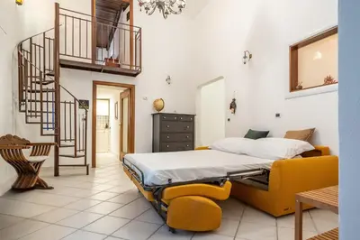 a bedroom with a bed and a staircase at A casa di GIO&GRACE in Palermo