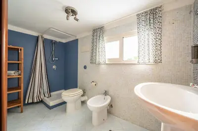 a bathroom with a tub and a toilet and a sink at A casa di GIO&GRACE in Palermo
