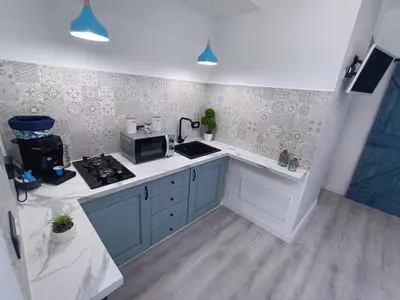 a kitchen with a sink and a microwave in it at Summer House in Isola delle Femmine