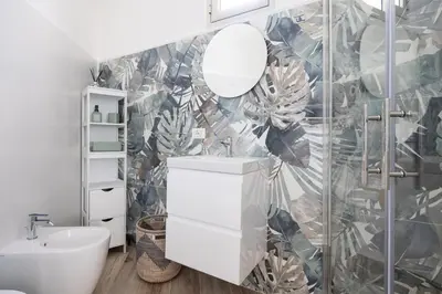 a bathroom with a white sink and a mirror at Uditore Mini Apartment in Palermo
