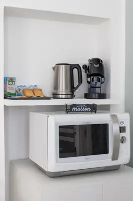 a microwave oven with a pot on top of it at Uditore Mini Apartment in Palermo