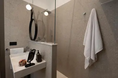 a bathroom with a sink and a mirror at Suite80 in Palermo