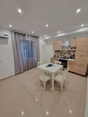 a dining room with a white table and chairs at Le casette di Elia e Alice in Palermo