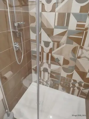 a shower with a glass door in a bathroom at Le casette di Elia e Alice in Palermo