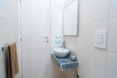 a bathroom with a bowl sink and a mirror at Casa vacanze CaMi in Alcamo