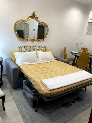 a bed in a room with a mirror on the wall at La Casetta di Fortunata in Palermo
