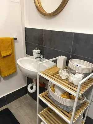 a bathroom with a sink and a toilet and a mirror at La Casetta di Fortunata in Palermo