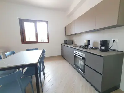 a kitchen with a table and a stove top oven at Apartment MareLuna by Interhome in Balestrate