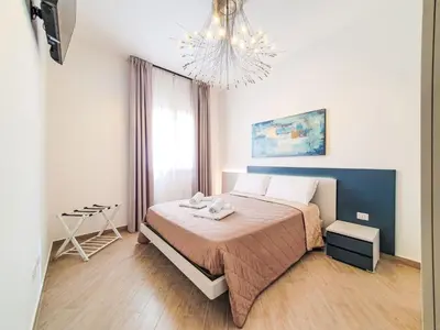 a bedroom with a bed and a chandelier at Apartment MareLuna by Interhome in Balestrate