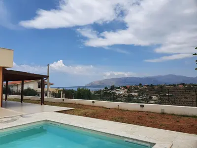 a swimming pool in a house with a view of the ocean at Apartment MareLuce by Interhome in Balestrate