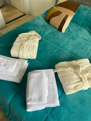 a bed with towels and towels on top of it at Da Andrea in Carini