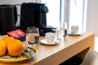 a table with a plate of oranges on it at Al Capo Suite Home in Palermo