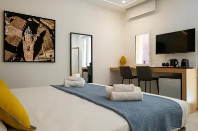a bedroom with a large bed with towels on it at Al Capo Suite Home in Palermo