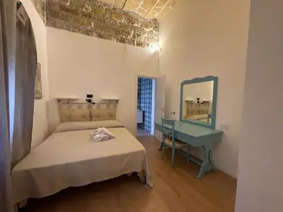 a bedroom with a bed and a mirror and a sink at Appartamento la Noce in Palermo