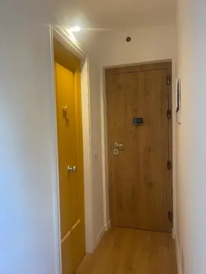 a hallway with a wooden door and a yellow door at Appartamento la Noce in Palermo