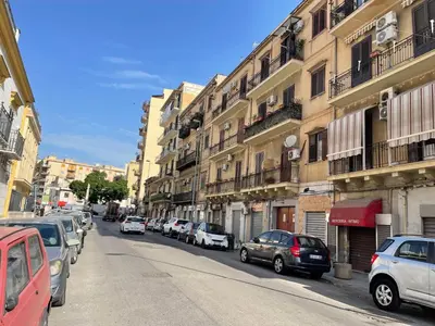 a street with cars parked on the side of the road at Appartamento la Noce in Palermo