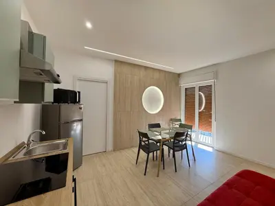 a kitchen and dining room with a table and chairs at Il Capriccio in Palermo