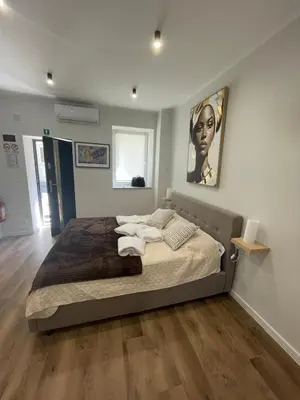 a bedroom with a bed with towels on it at Gold Rooms in Carini