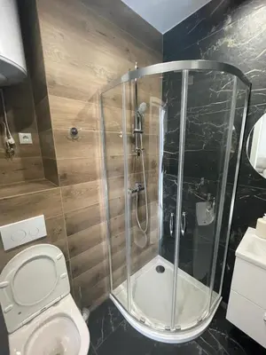 a bathroom with a shower and a toilet at Gold Rooms in Carini