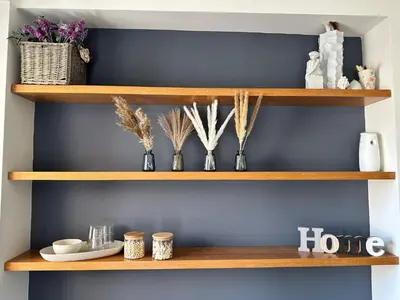 a row of wooden shelves with vases and flowers at Matteotti 17 Easy in Cinisi