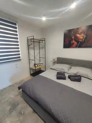 a bedroom with a large bed and a painting on the wall at Da Pietro in Carini