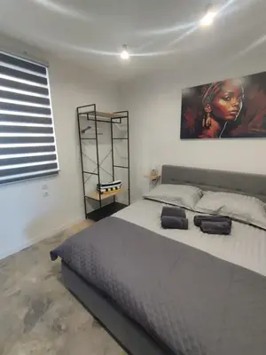 a bedroom with a large bed and a painting on the wall at Da Pietro in Carini