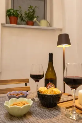 a small table with two chairs and wine glasses at Aromarìa Palace in Palermo