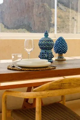 a table with a plate and a wine glass at Villa Ippolita - Studio with Esclusive Terrace in San Vito lo Capo