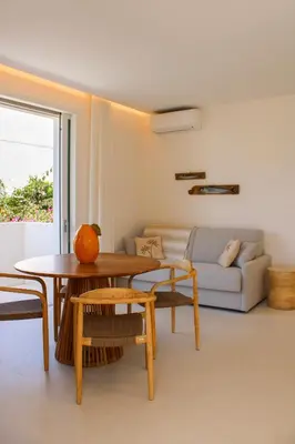 a living room with a table and a couch at Villa Ippolita - Apartment with Exclusive Garden in San Vito lo Capo