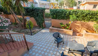 a patio with chairs and tables and a fence at Casa Leandra in Casteldaccia