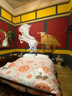 a bedroom with a bed with a horse on the wall at Hollywood Inn Palermo in Palermo
