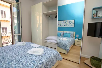 a small room with a bed and a mirror at Enjoy Palermo in Palermo