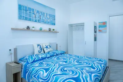 a blue bedroom with a bed with a blue at Casa Erasmo in Palermo