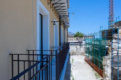 a building with a fence on the side of it at Casa Erasmo in Palermo