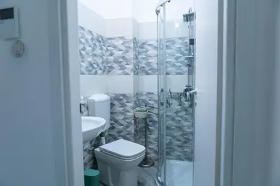 a bathroom with a shower with a toilet and a sink at Casa Erasmo in Palermo
