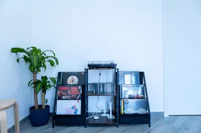 a room with a shelf with books and a plant at Casa Erasmo in Palermo
