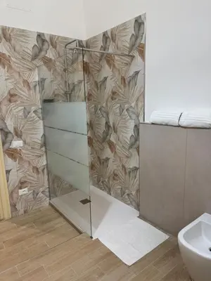 a bathroom with a shower with a mirror at Caltur B&B in Palermo
