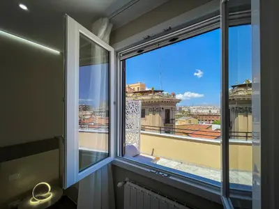 a window with a view of a city at Settimo Cielo al Massimo Guest House in Palermo