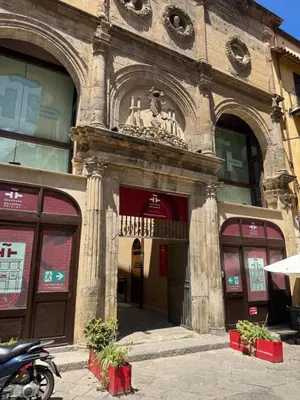 a building with a statue on the front of it at That's Amuri in Palermo