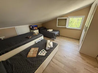 a small bedroom with two beds and a window at Villetta Sunrise by Holiday World in Lascari