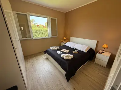a bedroom with a bed with two towels on it at Villetta Sunrise by Holiday World in Lascari