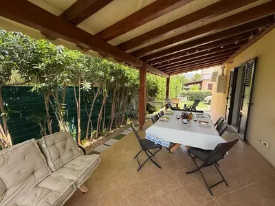 a patio with a couch and a table and chairs at Villetta Sunrise by Holiday World in Lascari
