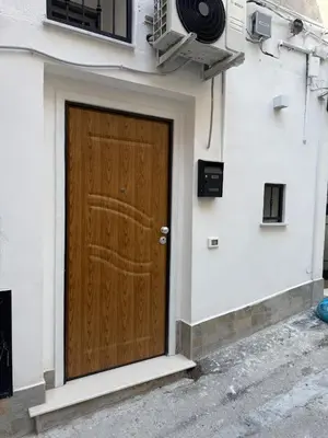 a brown door on the side of a building at Scialari - Palermo Holiday Home in Palermo