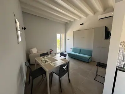 a living room with a table and a couch at Case Vacanze Villa Parisi in Bagheria