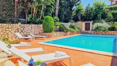 a swimming pool in a yard with a stone wall at Domus Dea in Mondello