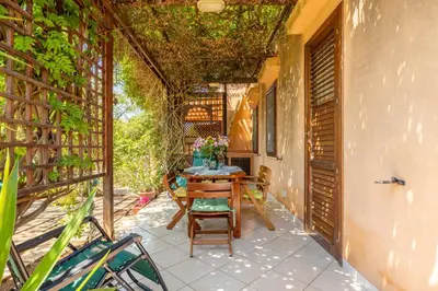 a small patio with a table and chairs on it at Acquamarina 24 in San Vito lo Capo