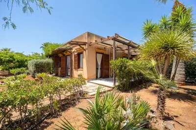 a house in the middle of a garden at Acquamarina 24 in San Vito lo Capo